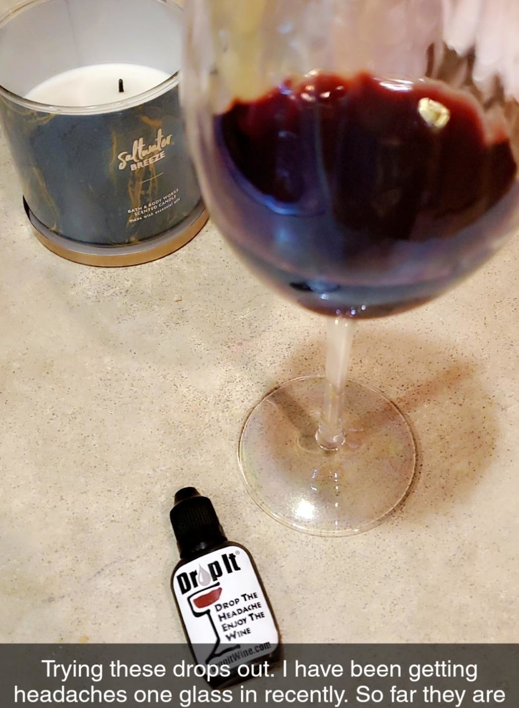 a glass of wine and the dropper bottle with text reading &quot;trying these drops out. I&#x27;ve been getting headaches one glass in recently. So far they are working and it makes the wine really smooth.&quot; 