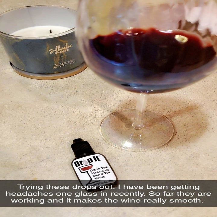 a glass of wine and the dropper bottle with text reading "trying these drops out. I've been getting headaches one glass in recently. So far they are working and it makes the wine really smooth." 
