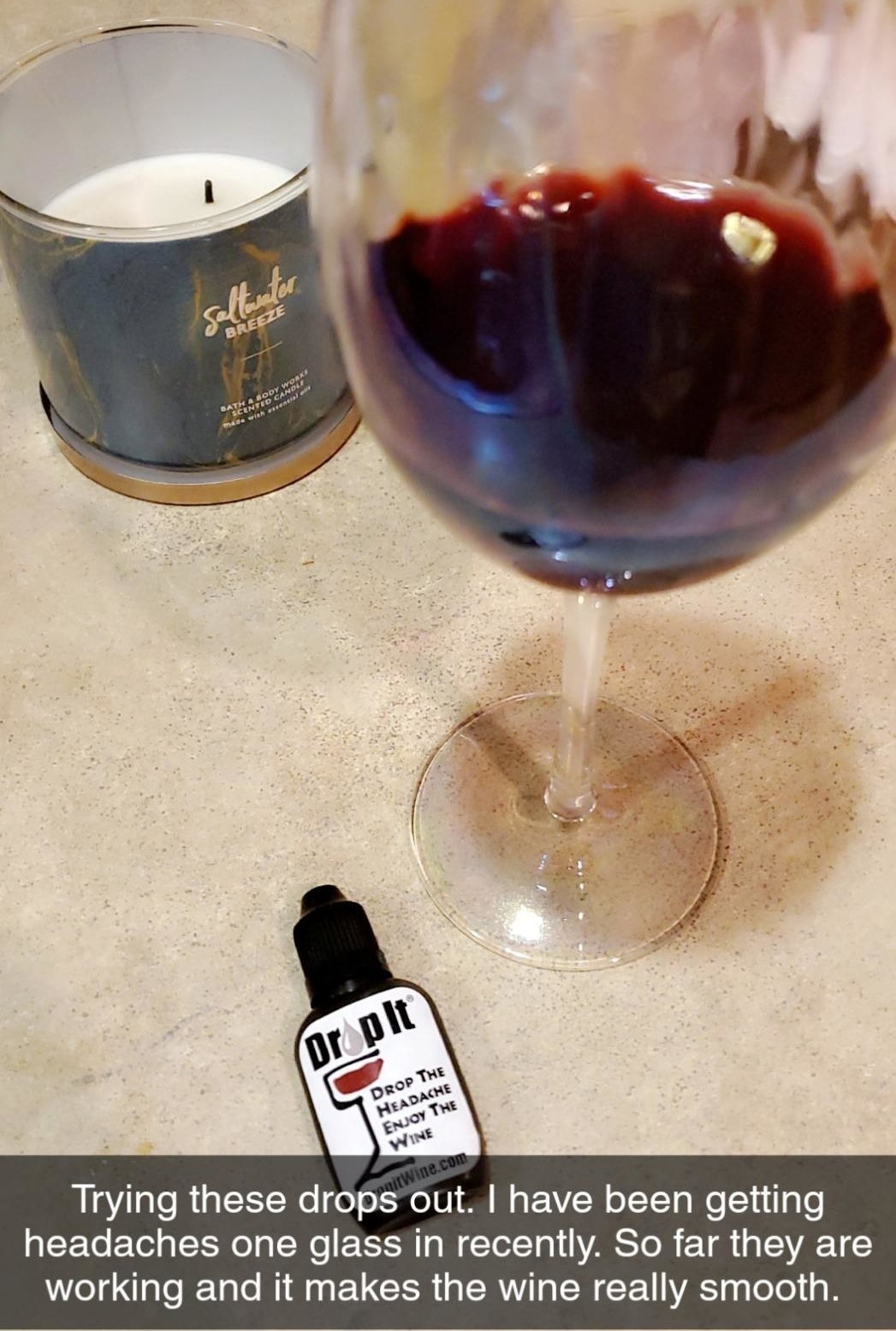 a glass of wine and the dropper bottle with text reading 