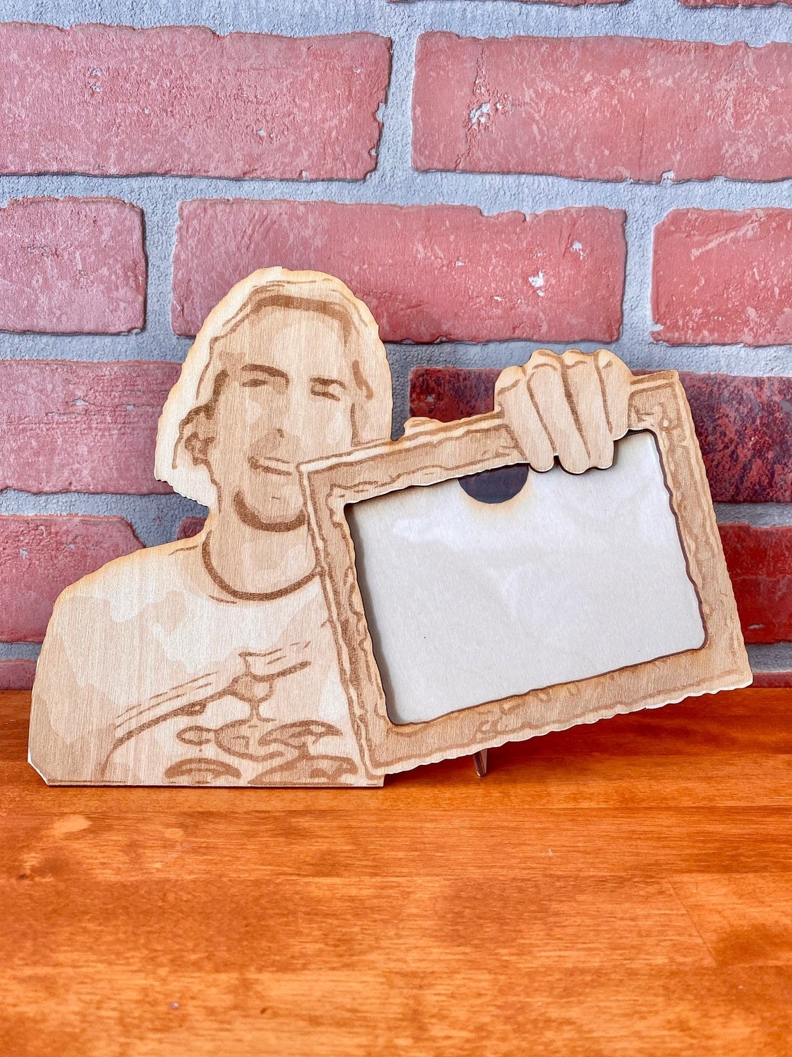 wood frame shaped like the meme of nickelback singer saying look at this photograph