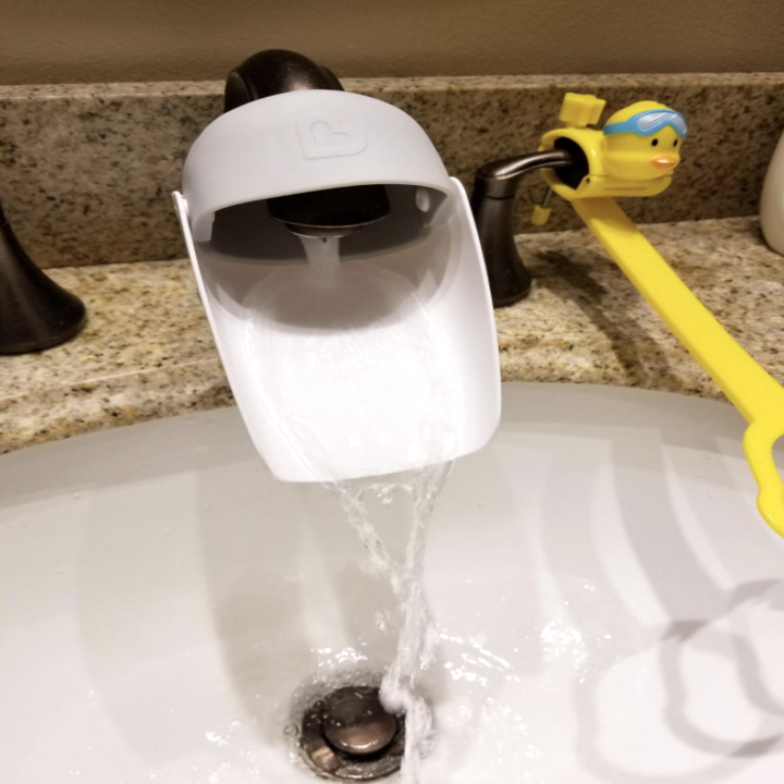 A faucet extender attached to a faucet