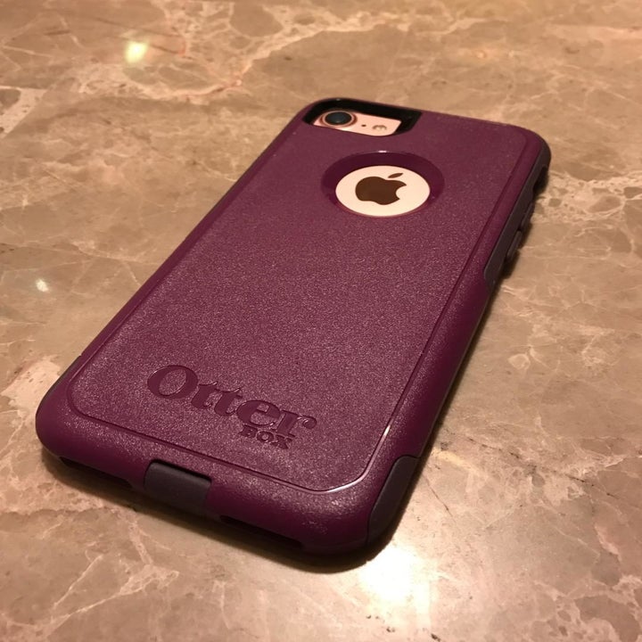a reviewer with a burgundy phone case 