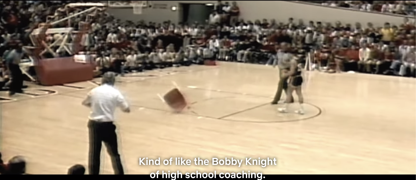 Singer throwing a chair in the middle of the court during a basketball game