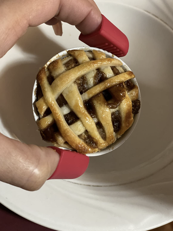 Reviewer holding a mini pie