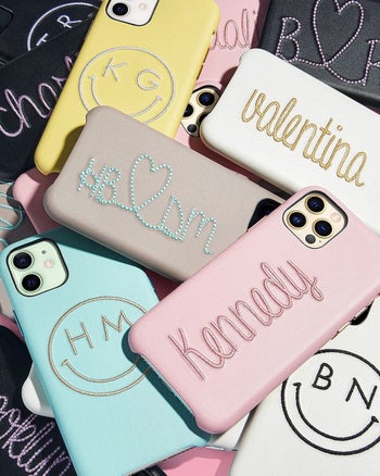 a pile of different colored phone cases with various things embroidered on them