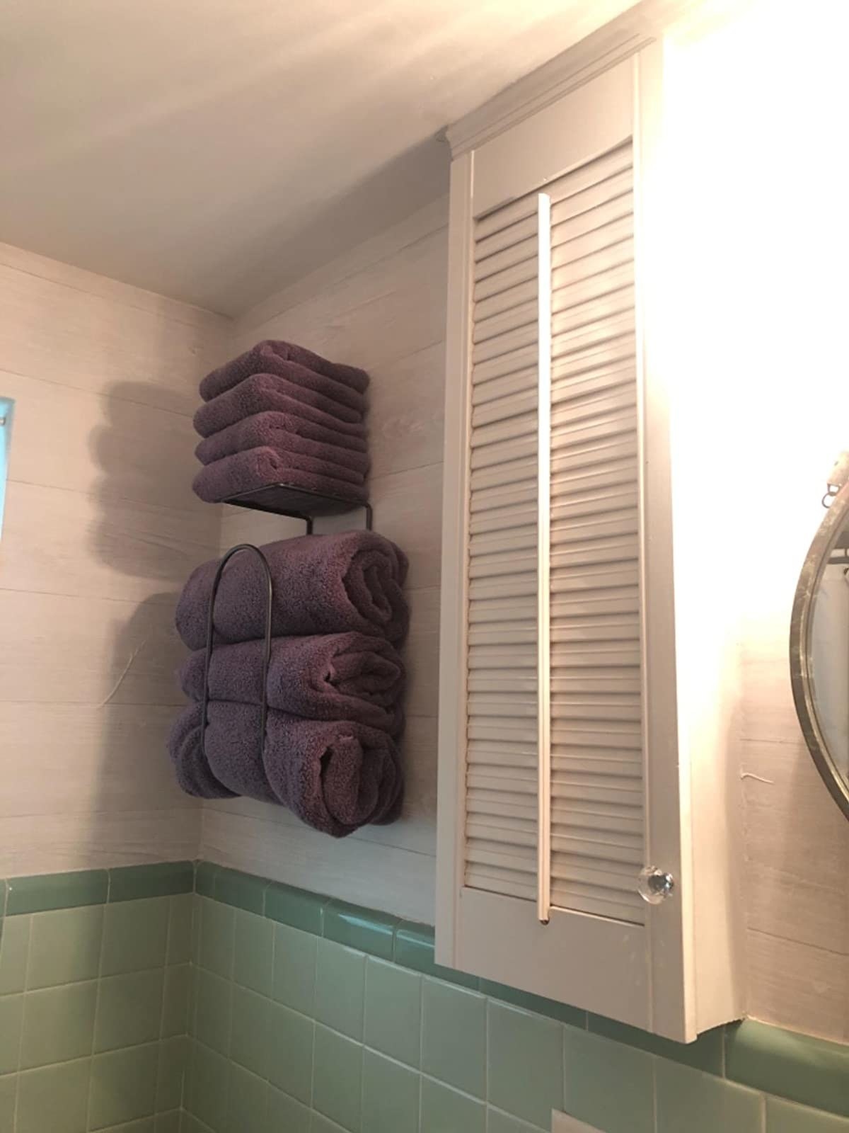 The purple towels hanging in a bathroom
