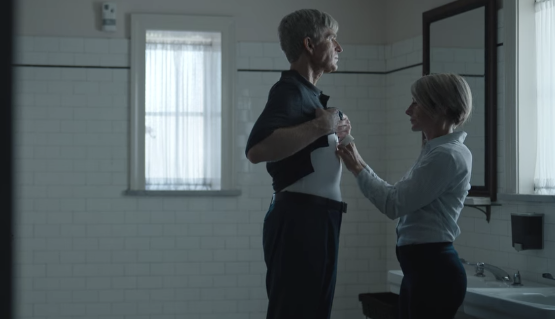 Singer getting a wire taped to his chest