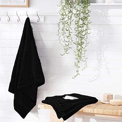 The black towel hanging in a bathroom