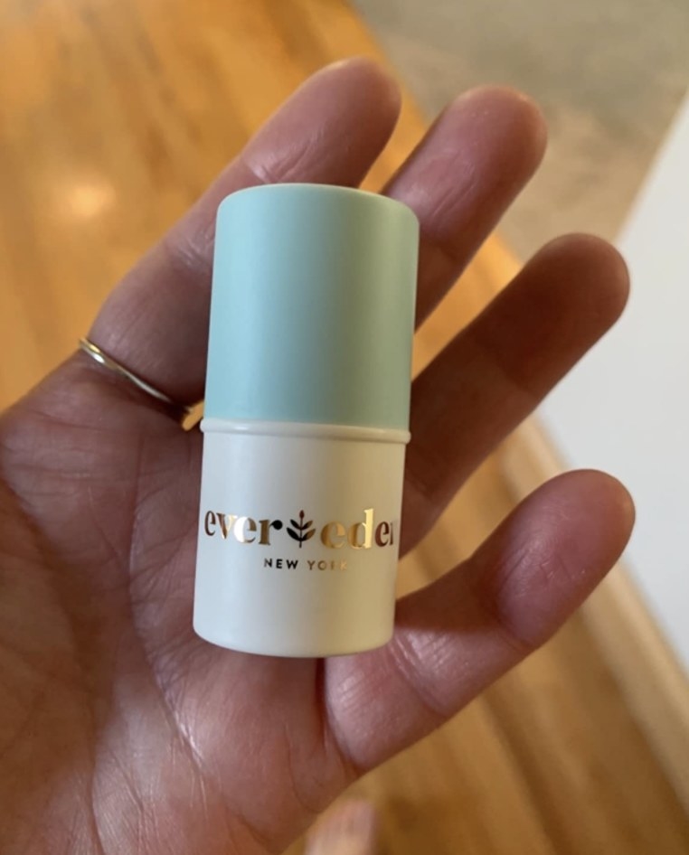 a person holding the lip balm