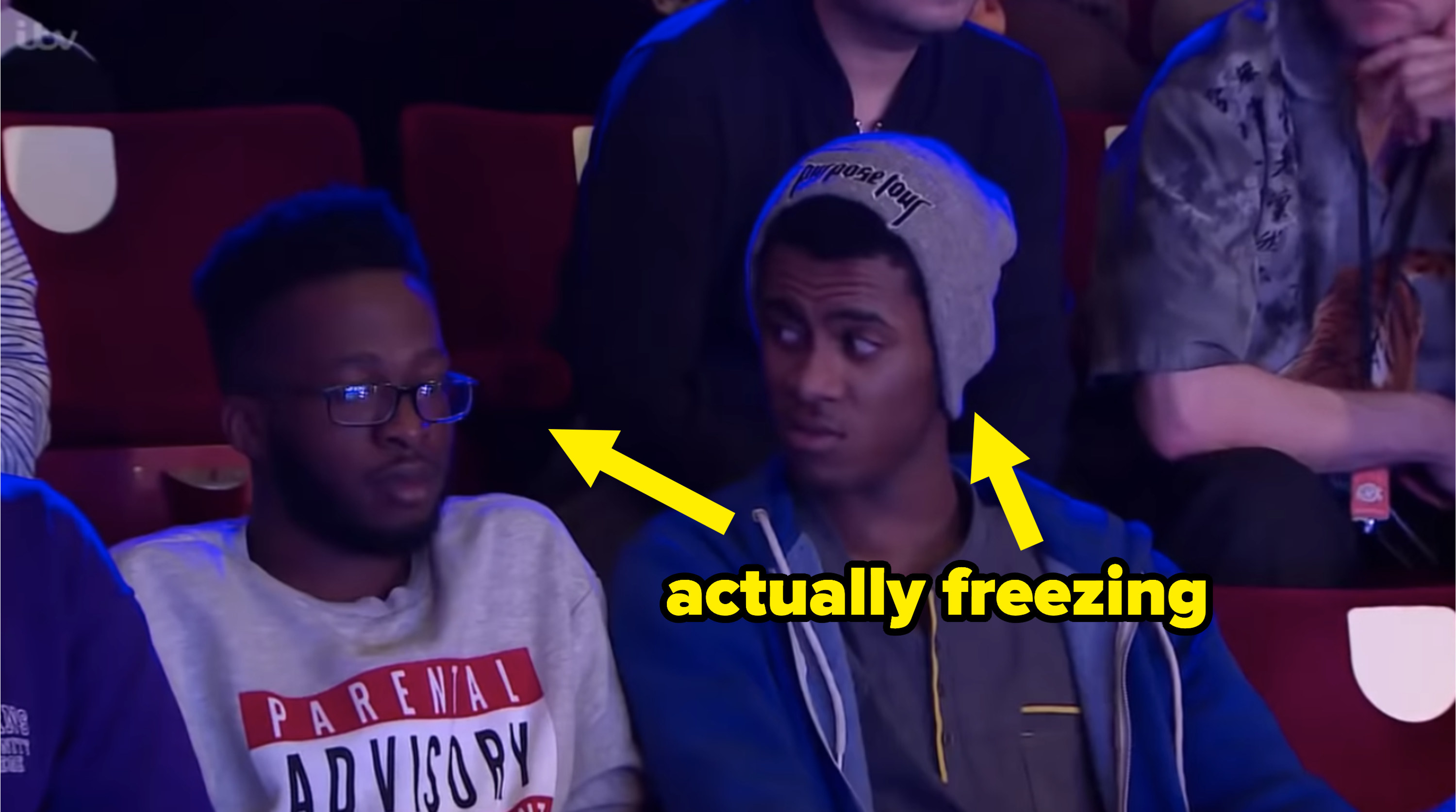 two audience members with an arrow pointing to them that says, "actually freezing"