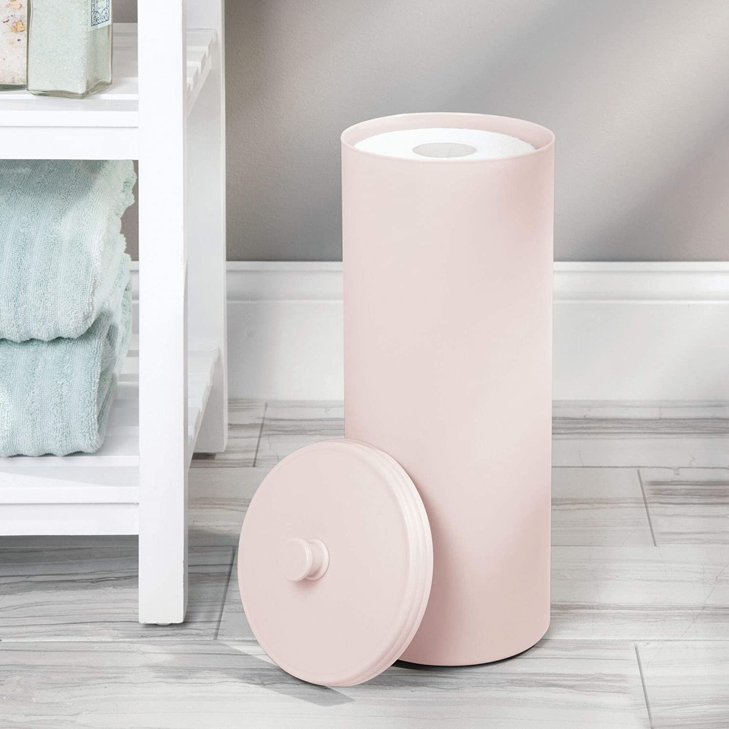 The canister in pink filled with toilet paper