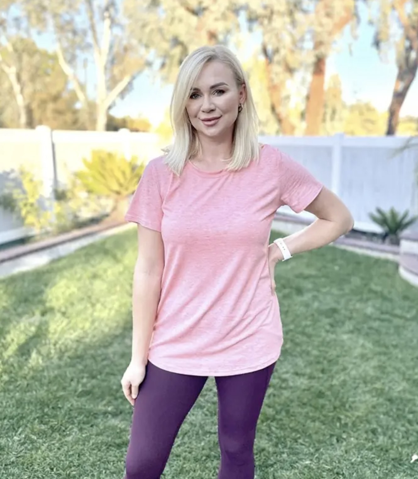 Person is wearing a pink T-Shirt and purple leggings