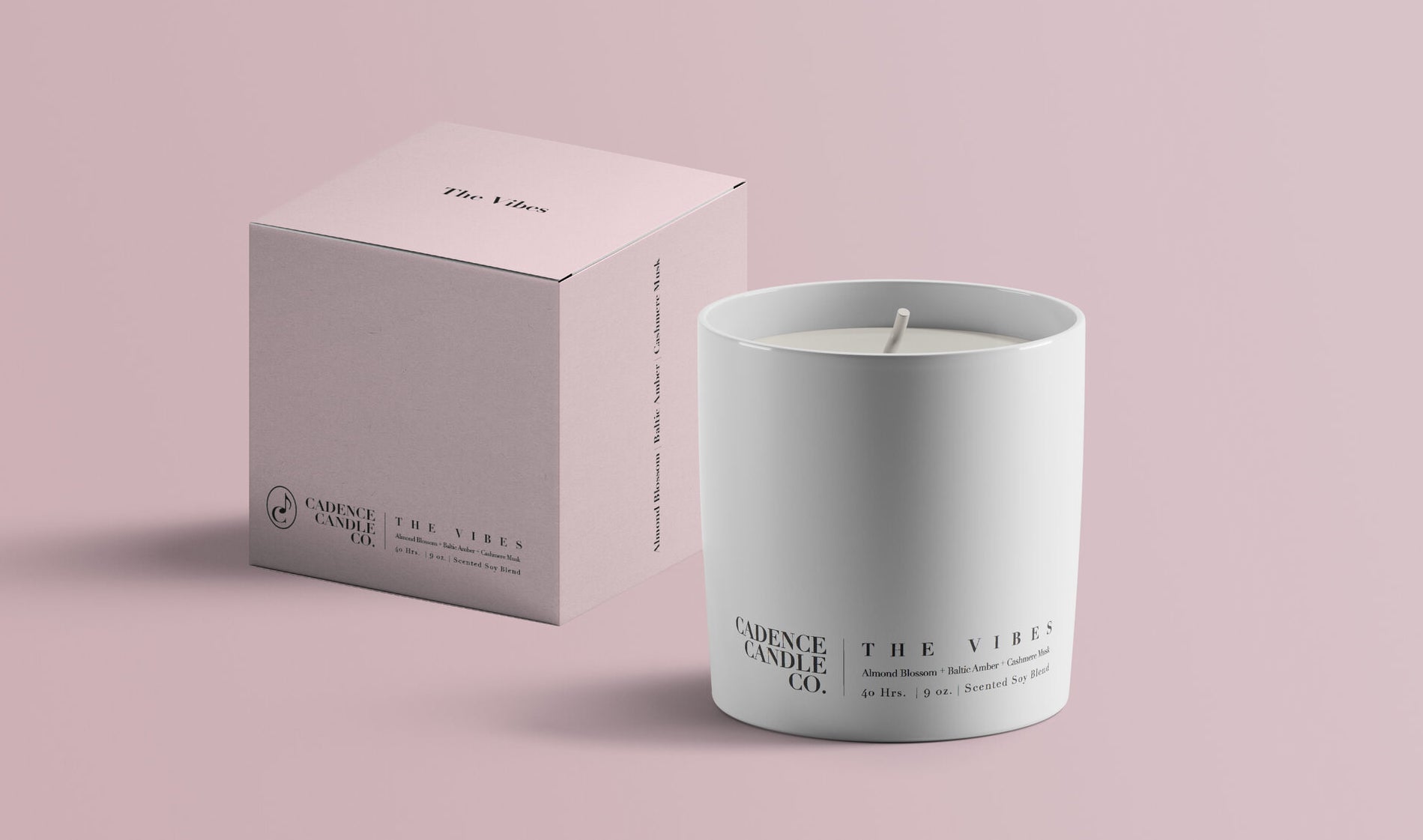 a white candle that says "the vibes" on it next to a pale blue box