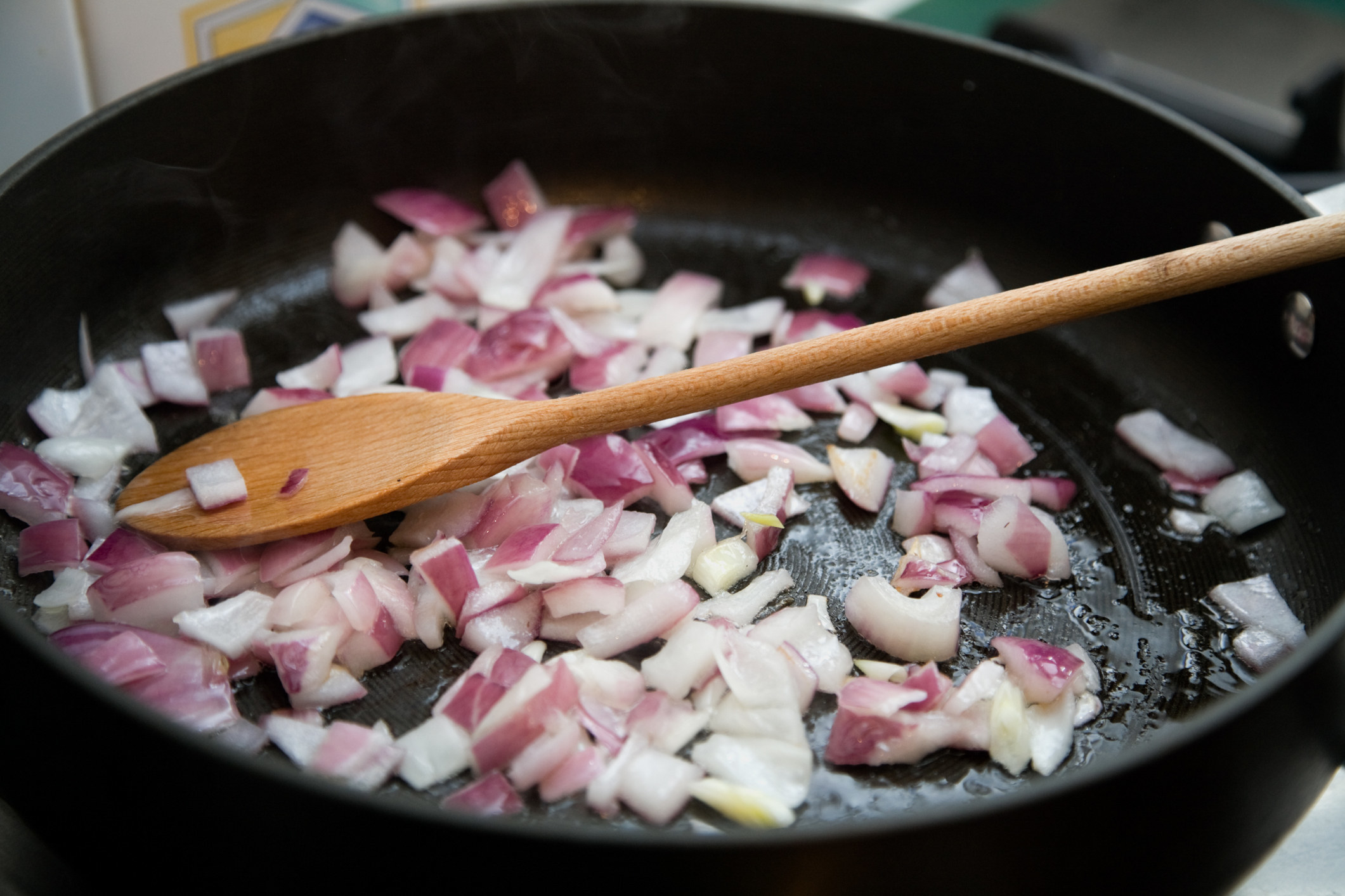 Frying onions in a skillet.