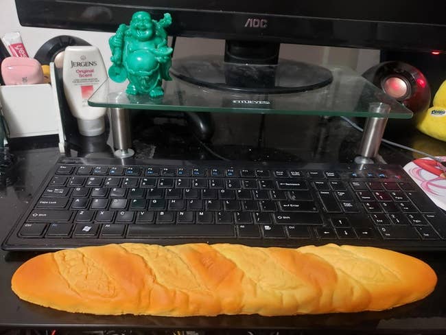 A reviewer's bread-shaped rest in front of their keyboard