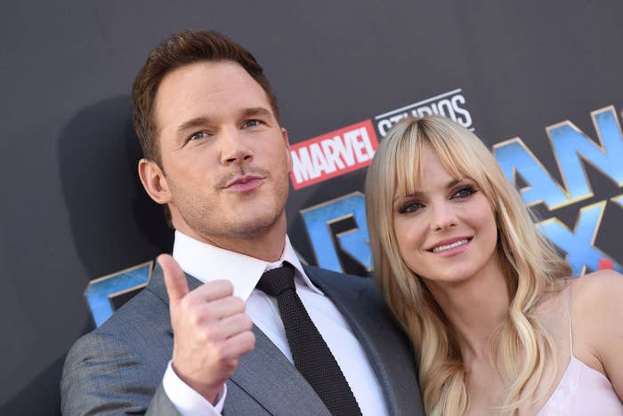 Chris giving a thumbs up as he poses with Anna on a red carpet