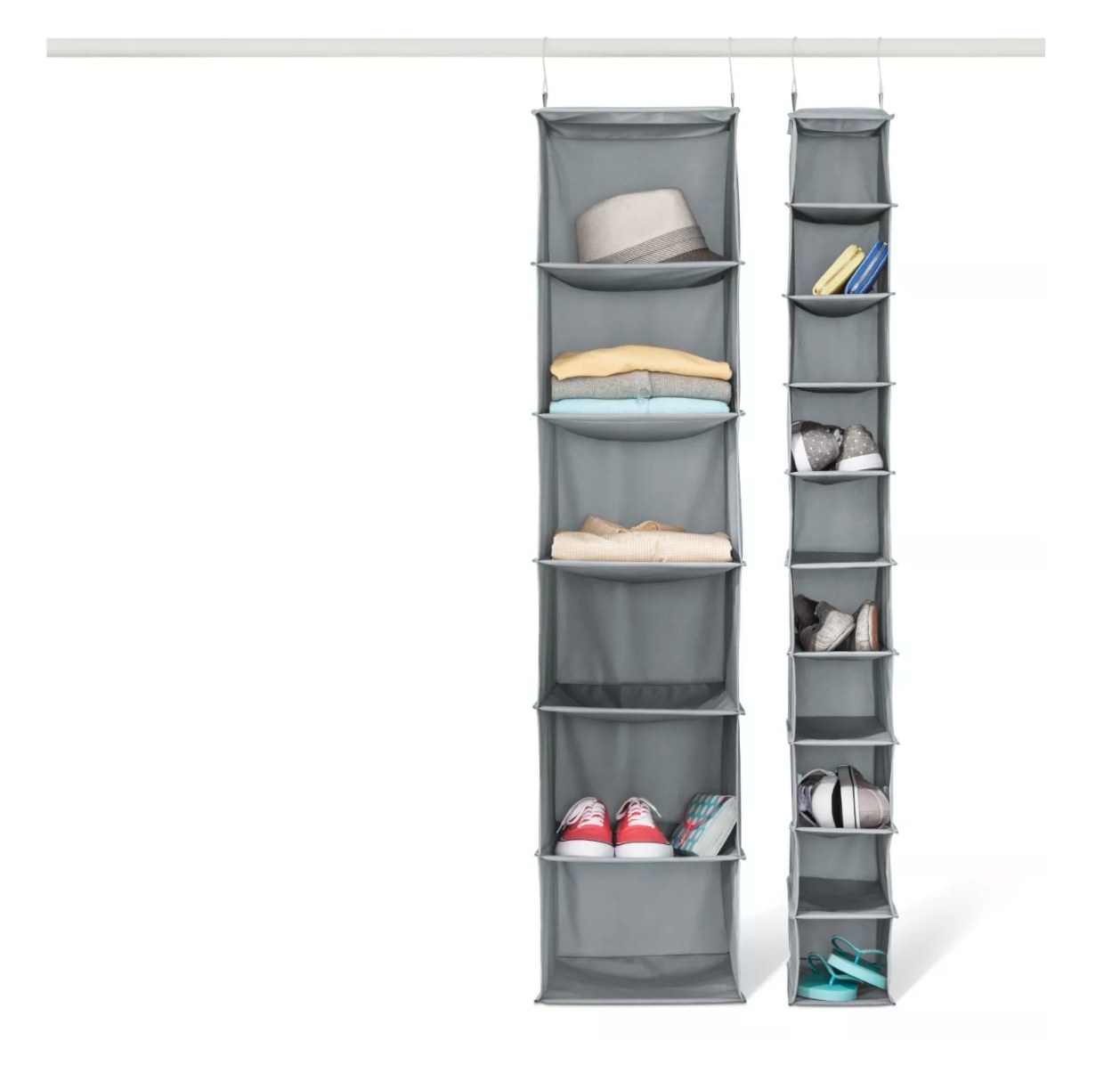 The shoe storage organizer holding folded sweaters and sneakers