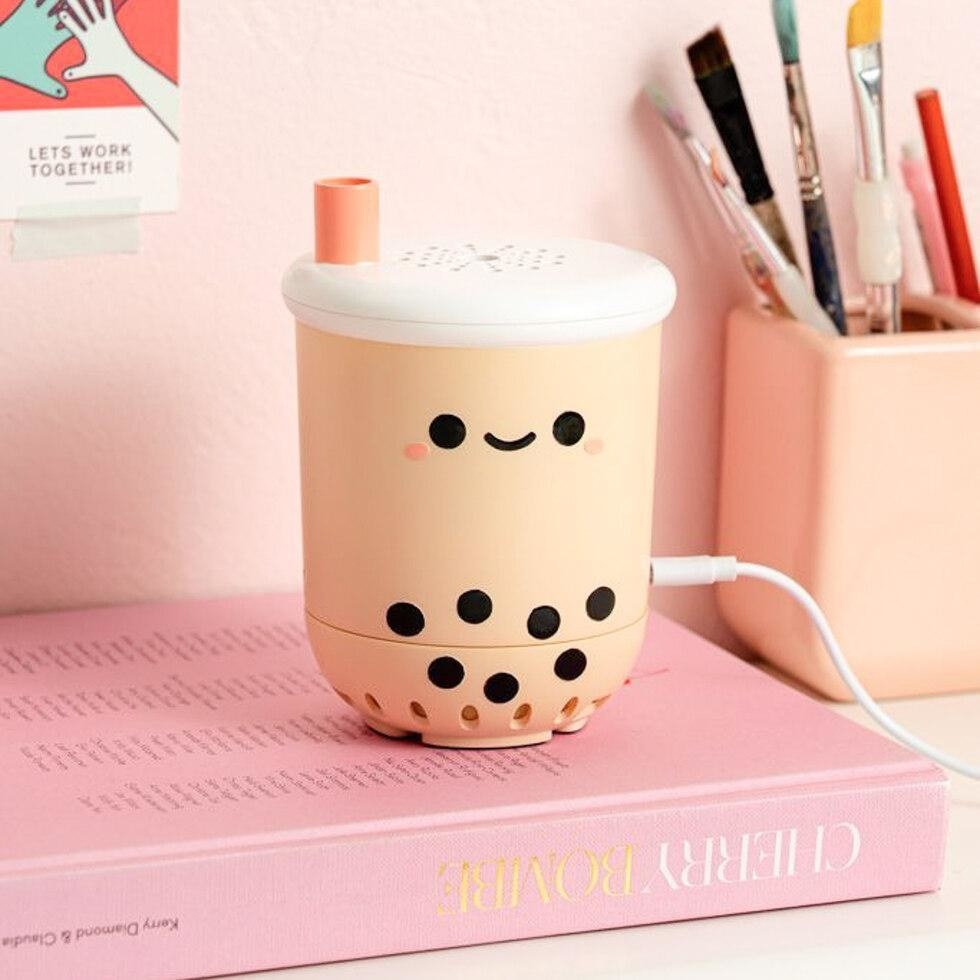 the pearl boba tea air purifier atop a big pink book