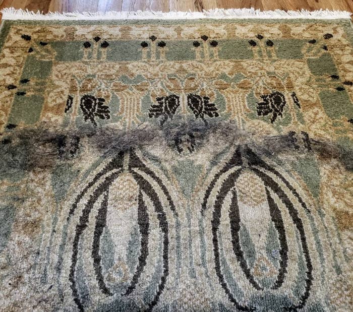 A rug with hair coming off it