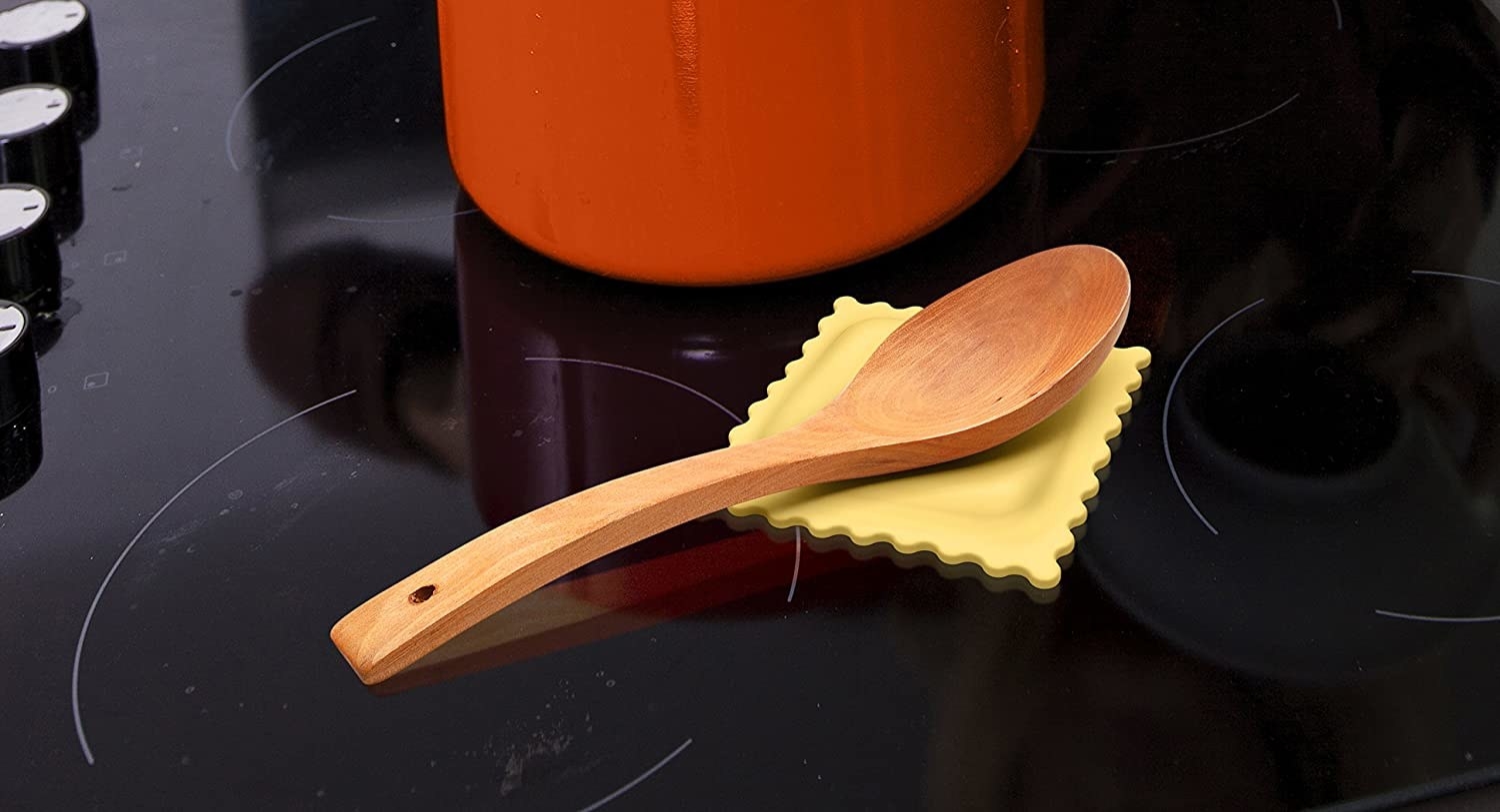 a wooden spoon rests on the ravioli spoon rest