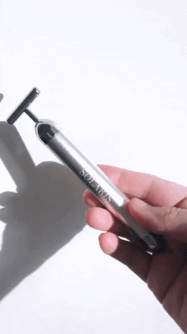 A gif of someone holding the vibrating wand