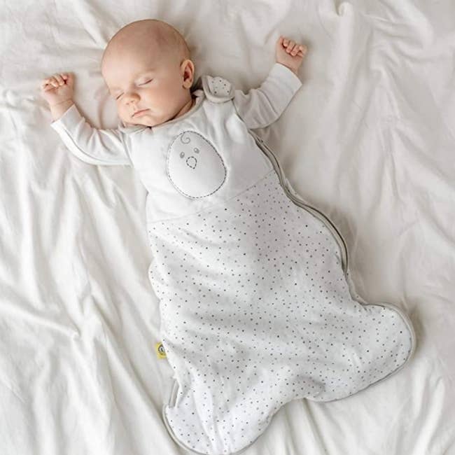 A baby wearing a weighted sleep sack in bed