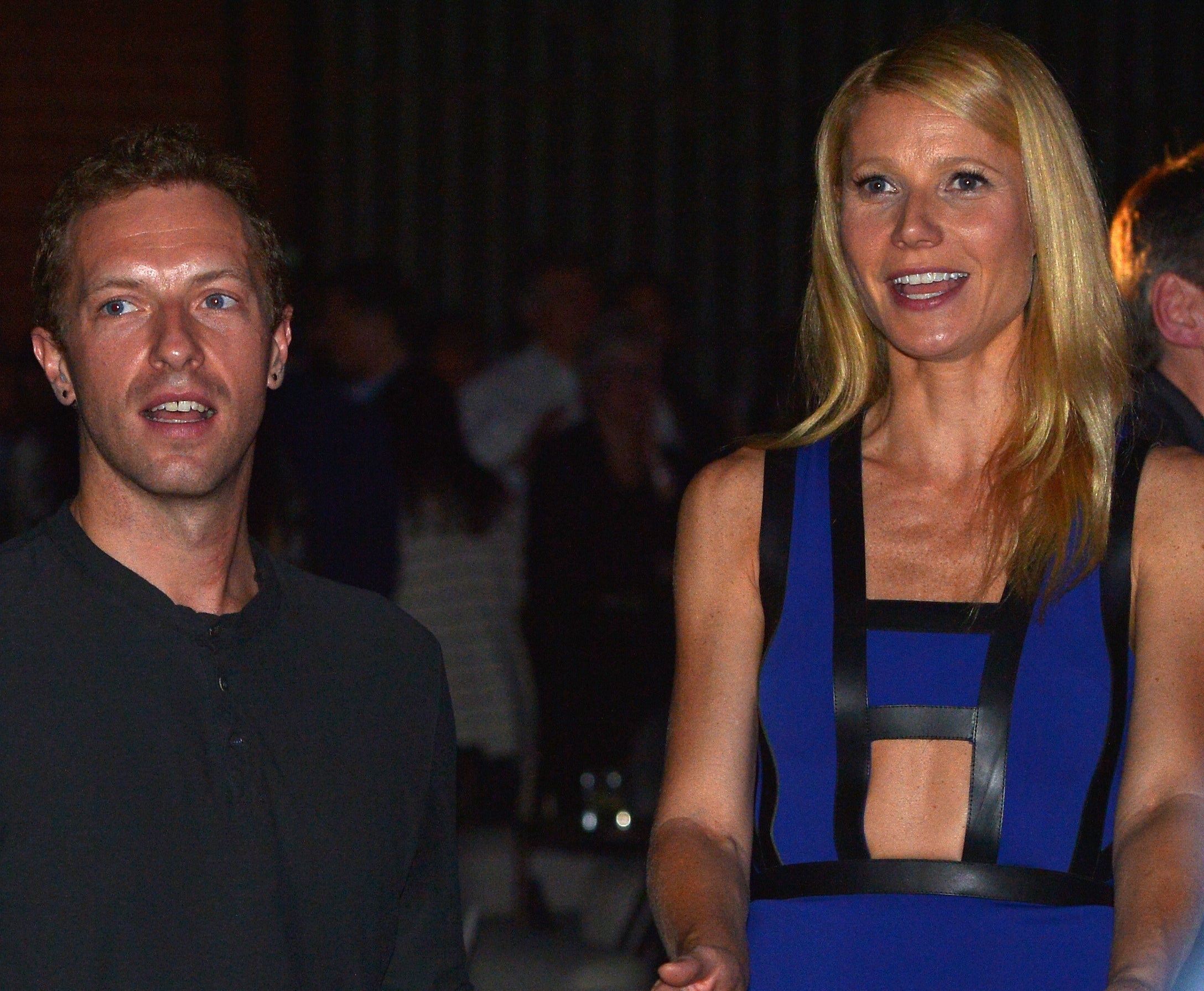 Gwyneth sits next to Chris at an event