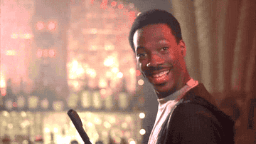 Axel Foley gives an open-mouthed smile and holds his hands in an &quot;ok&quot; gesture in Beverly Hills Cop