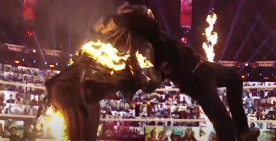 Man attacking wrestler while on fire.