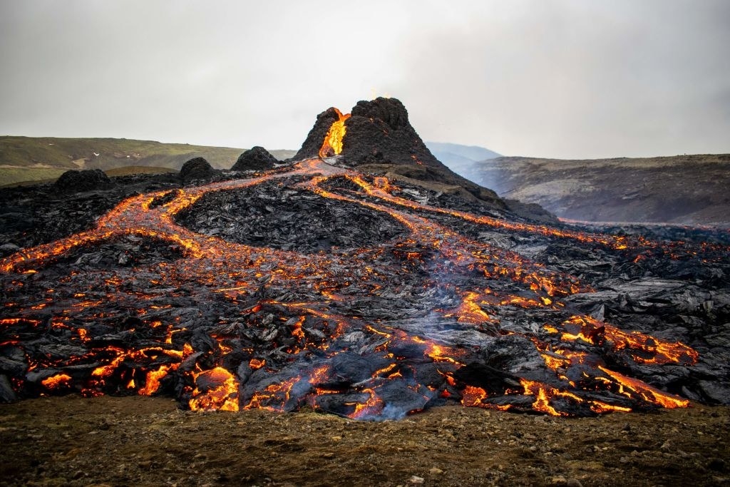 A volcano bubbled red-hot lava across an open field