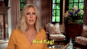 A woman pretending to wave a flag while saying, &quot;red flag!&quot;
