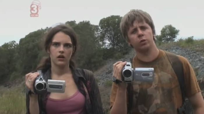 Harry and Lucy looking confused while holding up camcorders