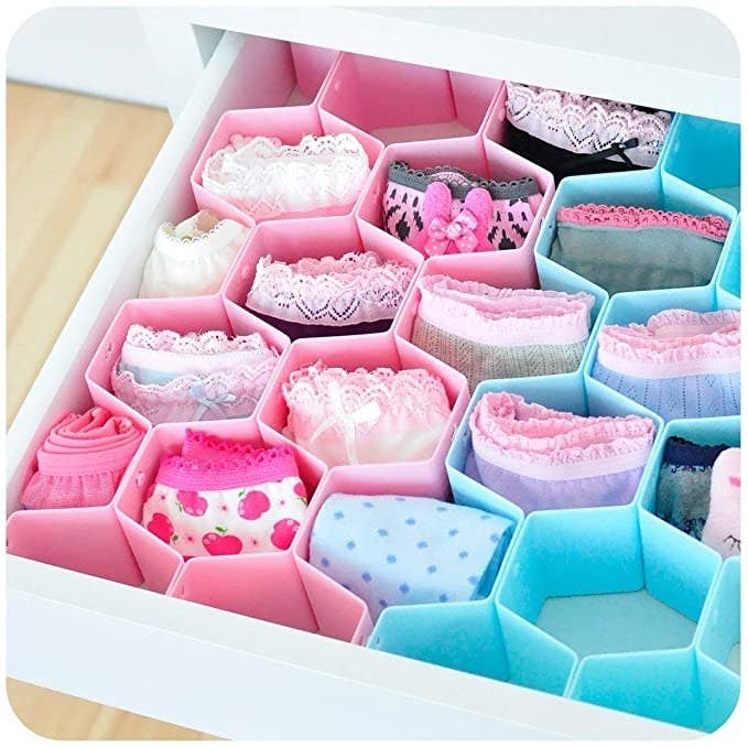 Pink and blue honeycomb organisers with undergarments in them.