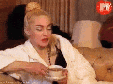 Madonna sipping TV during an interview on MTV