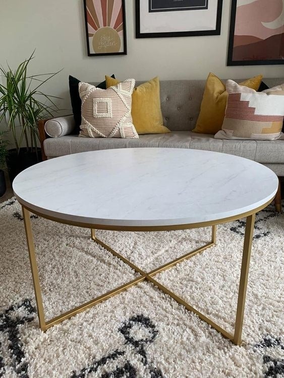 Reviewer&#x27;s picture of the marble-top round table with gold legs