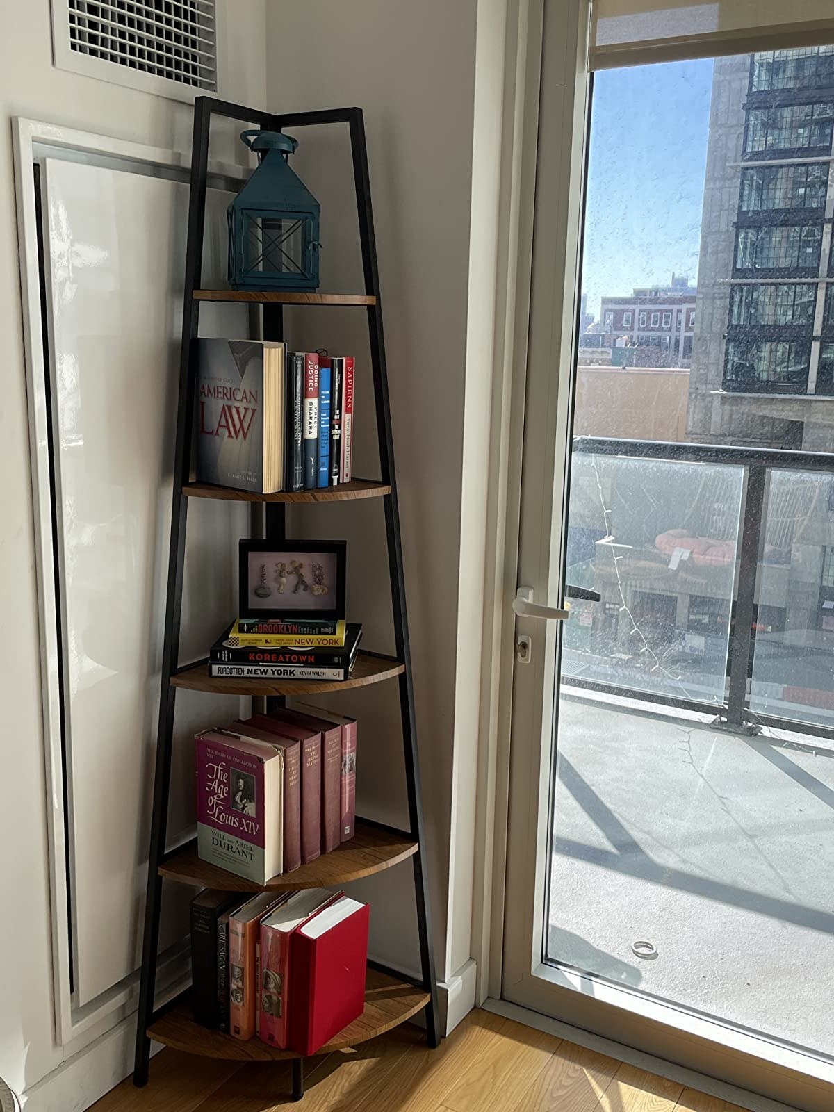 tall black and brown bookcase in a corner