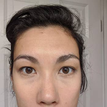 same reviewer showing their dark circles completely gone after using the concealer 