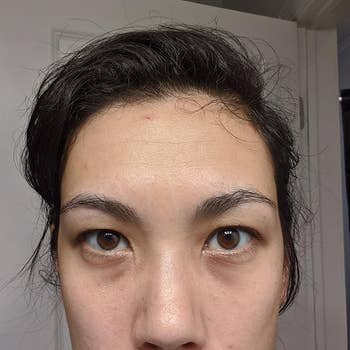 reviewer selfie showing the dark circles under their eyes before applying the concealer