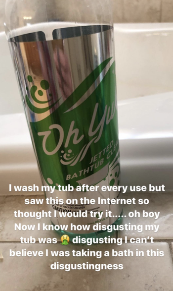 A customer review photo of a bottle of Oh Yuk Jetted Tub Cleaner and text talking about how despite cleaning their tub after every use it was still disgusting