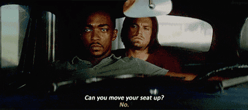 a man sits behind another man&#x27;s seat in a car, saying &quot;can you move your seat up?&quot; the man in front says, &quot;no&quot;