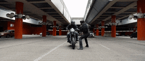 a man on a motorcycle flies through the air, still on the motorcycle