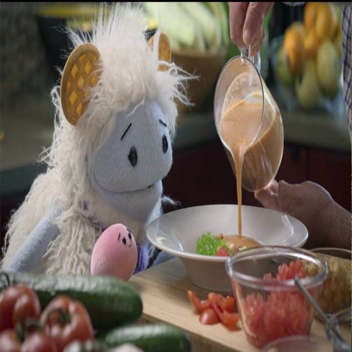 Waffles and Mochi watch Chef Andres pour gazpacho. 