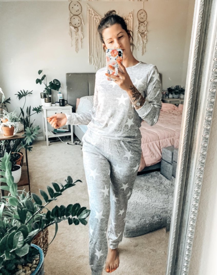 Reviewer photo of a person wearing a grey pajama set with white stars all over it