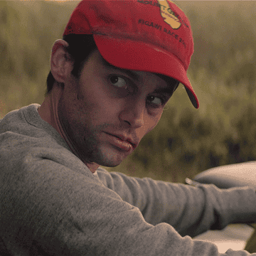 Penn Badgley from You Lifetime movie wearing a red baseball cap