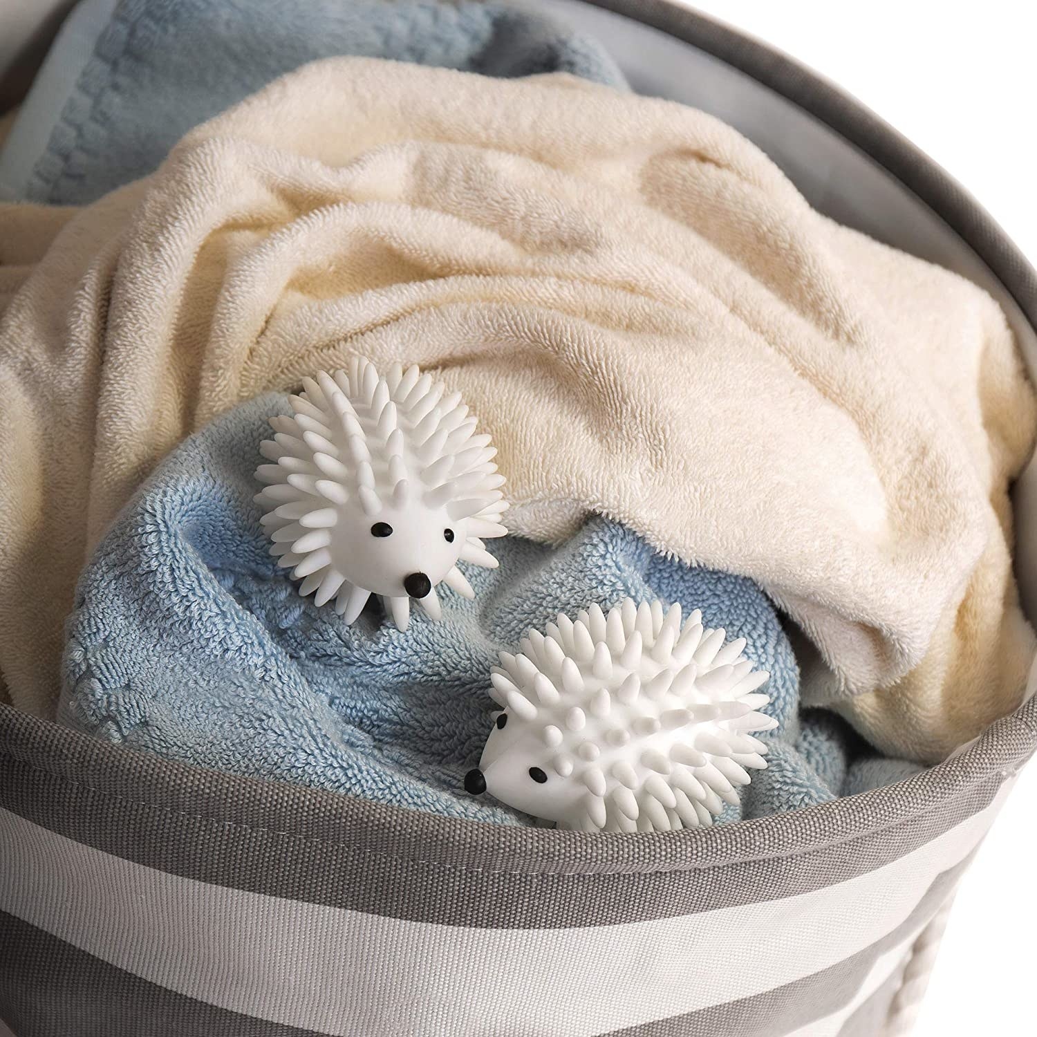 The two white hedgehogs in a pile of towels