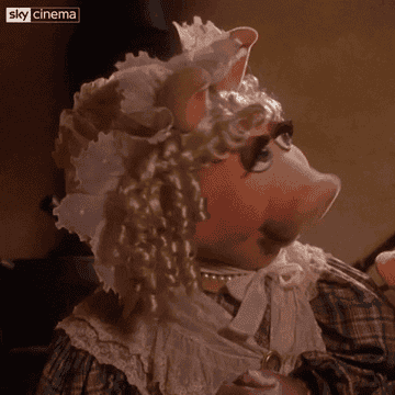 A gif of Miss Piggy saying whatever