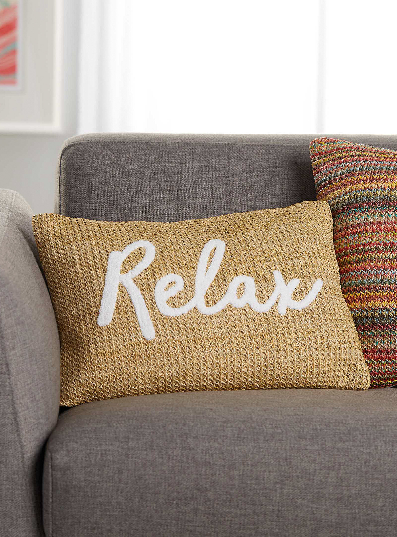 the pillow on a couch that says relax