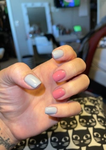 person with a pink and gray at home manicure