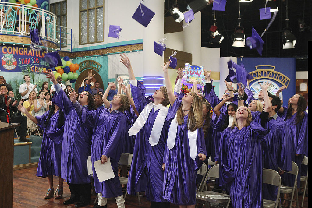 Cole Sprouse and Dylan Sprouse throwing up their caps with their fellow graduates in &quot;Graduation on Deck&quot; episode