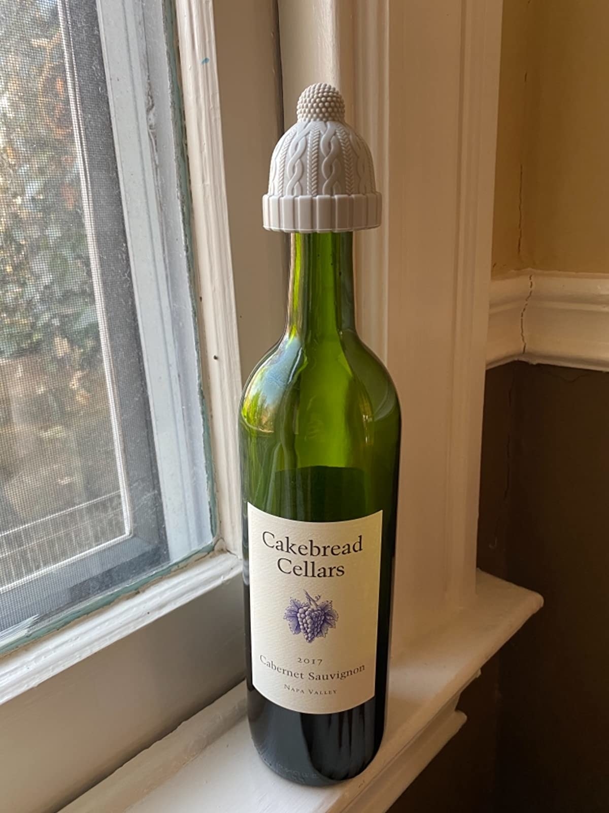 Reviewer photo of beanie-shaped wine stopper on wine bottle